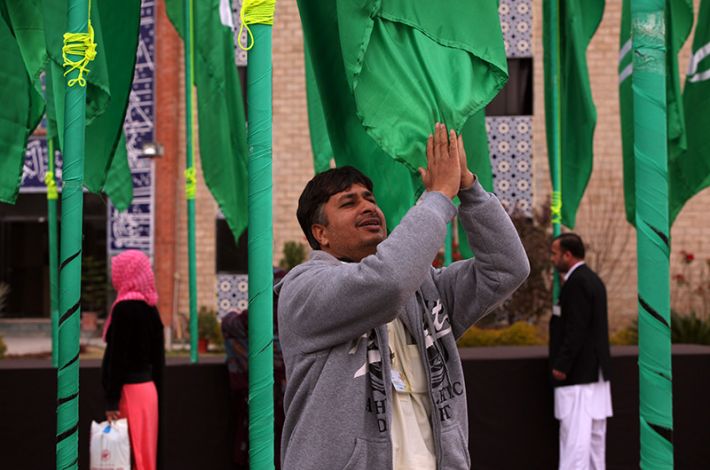 A Visitor Seeking Blessing Through the Banner